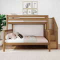 Wooden bunk bed with stairs in a modern kids' bedroom featuring pink and white bedding, striped accent pillow, framed animal wall art, potted plant and textured area rug