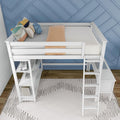 White loft bed with ladder and built-in desk, blue geometric accent wall, colorful throw pillows and peach blanket in modern kids' bedroom