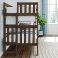 Dark wood bunk bed in bright coastal-style kids' bedroom with blue curtains, fiddle leaf fig plant, patterned wallpaper and white bedding