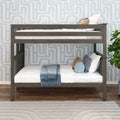 Gray wooden twin bunk bed in a modern kids bedroom with white and blue bedding, textured light-blue geometric wallpaper, decorative pillows and hardwood floors
