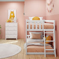 Pastel pink kids' bedroom with white wooden bunk bed, peach bedding, orange cushions, dresser, framed cat print and bunting