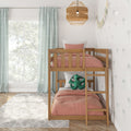 Wooden bunk bed with blush pink bedding in bright kids' bedroom with green gingham curtains, rattan pendant light and palm wallpaper