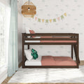 Wooden bunk bed in children's room with coral bedding, green gingham curtains, palm-print wallpaper, bunting, and rattan pendant light