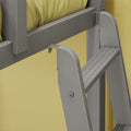 Close-up of gray wall-mounted folding step ladder showing metal bracket, hinge, bolts and textured yellow wall background