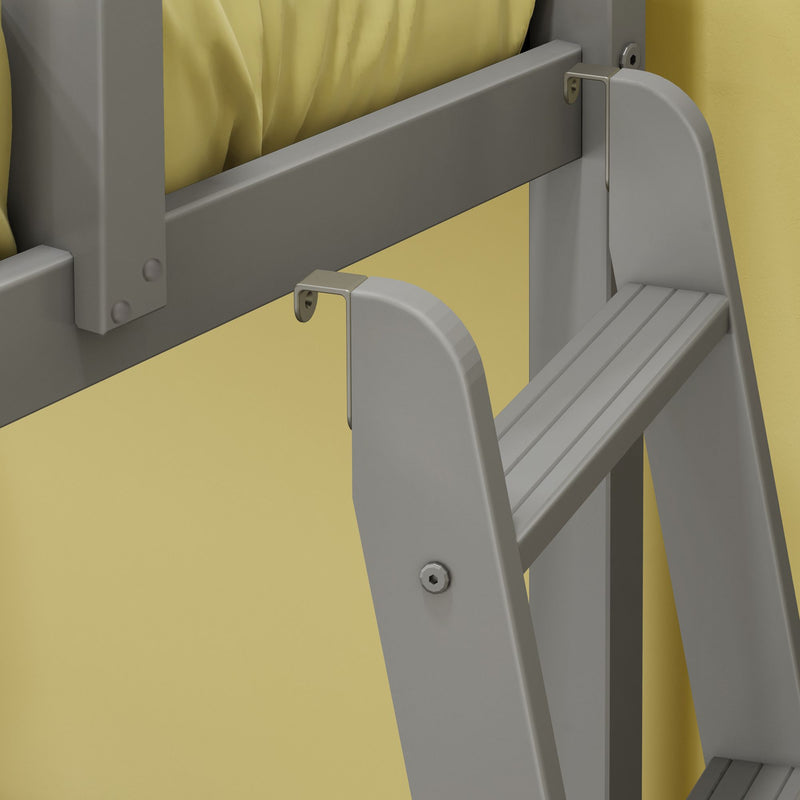 Close-up of gray wall-mounted folding step ladder showing metal bracket, hinge, bolts and textured yellow wall background