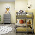 Modern yellow kids bedroom with gray bunk bed, lion throw pillow, tassel garland, framed leopard wall art, gray dresser and polka dot rug