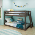Dark wood twin-over-full bunk bed in a coastal kids' bedroom with aqua walls, striped rug, decorative garland, shark plush and star pillows