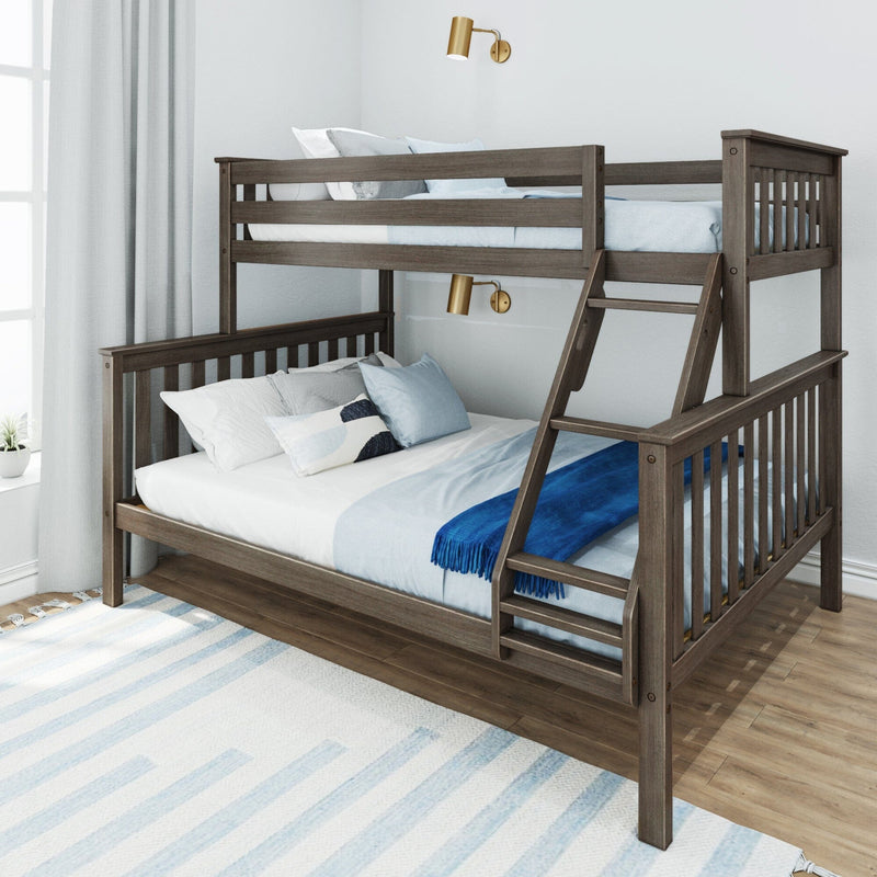Grey oak twin-over-full wooden bunk bed with ladder, blue bedding, pillows and brass wall sconces in bright kids' bedroom