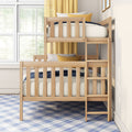 Natural wood twin-over-twin bunk bed in bright kids' bedroom with ladder, yellow curtains, blue plaid rug, decorative pillows and large window