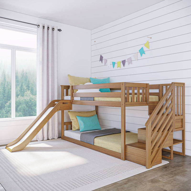 Wooden bunk bed with slide in bright kids' room with white shiplap wall, pastel pillows, bunting and large window.