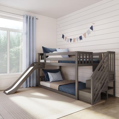 Gray wooden bunk bed with slide and stairs in bright modern farmhouse kids' bedroom, blue pillows and curtains, shiplap wall with pastel bunting