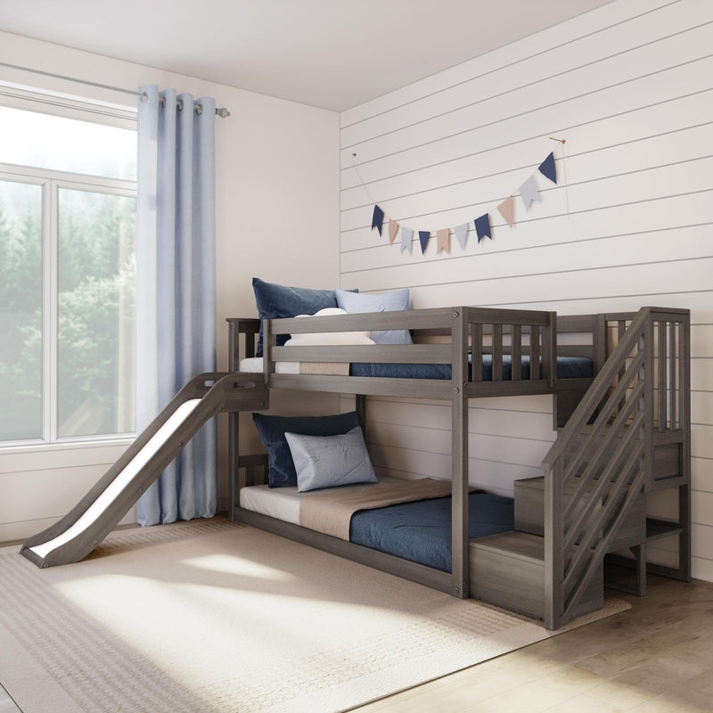Gray wooden bunk bed with slide and stairs in bright modern farmhouse kids' bedroom, blue pillows and curtains, shiplap wall with pastel bunting