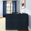 Cozy modern living room corner with navy blue sofa and red accent pillows, light-blue striped wallpaper, sheer navy curtains over a wooden window, framed red toy car wall art, beige rug and hardwood floor, natural light, stylish home decor interior