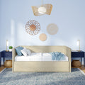 Beige upholstered daybed in boho coastal bedroom with blue pillows, woven rattan wall decor, rattan pendant light and navy bedside tables