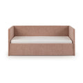 Blush pink upholstered daybed with high back and side panels and white mattress, modern fabric daybed isolated on white background