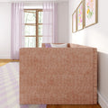 Cozy modern living room interior with blush pink sofa, sheer pink curtains, wooden window frame, pastel floral wall art and light checkered rug