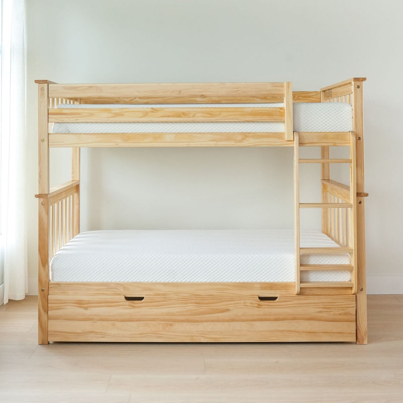 Pine wooden bunk bed with ladder, under-bed storage drawer and white mattresses in a bright minimalist bedroom