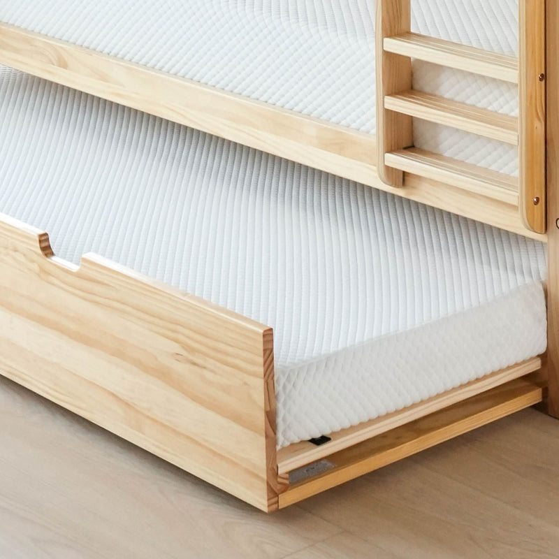 Pine bunk bed frame close-up with white quilted mattress, solid wood ladder and minimalist natural wood bedroom design