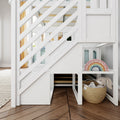 White wooden bunk bed with diagonal railing, striped kids bedding, wicker storage basket holding a plush bunny and pastel wooden rainbow toy