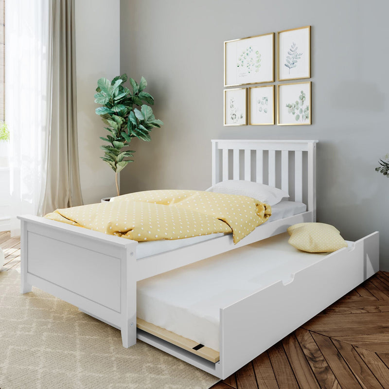 White kids' trundle bed with yellow polka-dot duvet, pull-out storage mattress, botanical wall art and indoor plant in a neutral modern nursery