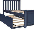 Navy blue wooden bed frame with vertical slatted headboard, wooden slat platform and underbed trundle on casters
