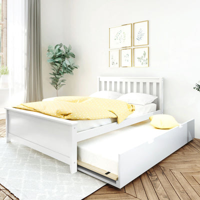 White wooden bed with pull-out trundle and yellow polka-dot duvet in a minimalist bedroom with botanical wall art, fiddle-leaf plant and natural light