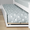 White wooden twin trundle bed with gray giraffe-print duvet on lower pull-out mattress in children's bedroom