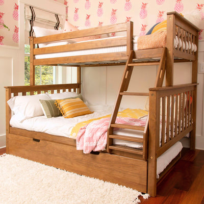 Solid wood bunk bed with ladder and trundle drawer in a children's bedroom with pink pineapple wallpaper and colorful throw pillows