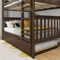 Dark walnut wooden bunk bed with ladder, slatted rails and pull-out trundle mattress, styled with yellow pillows and cozy bedding in a children's bedroom.