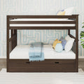 Dark wood twin-over-twin bunk bed with under-bed storage drawer, white bedding, light blue throw and decorative yellow and striped pillows in a modern children's bedroom with geometric wallpaper