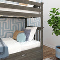 Gray wood twin bunk bed with under-bed storage drawer, white bedding, blue throw and decorative pillows against blue geometric wallpaper in a modern kids' bedroom with fiddle-leaf plant