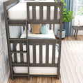 Gray wooden twin-over-twin bunk bed in a modern kids' bedroom with white striped bedding, blue round pom-pom pillow, tan accent pillow, ladder and potted plant