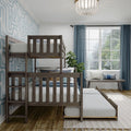 Wooden bunk beds with pull-out trundle in a bright kids' bedroom featuring blue geometric wallpaper, sheer blue curtains, large window, green plant and cozy pillows