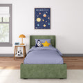 Modern kids bedroom with green twin bed, rocket and star pillows, orange bedside lamp, soccer ball and framed solar system poster wall art