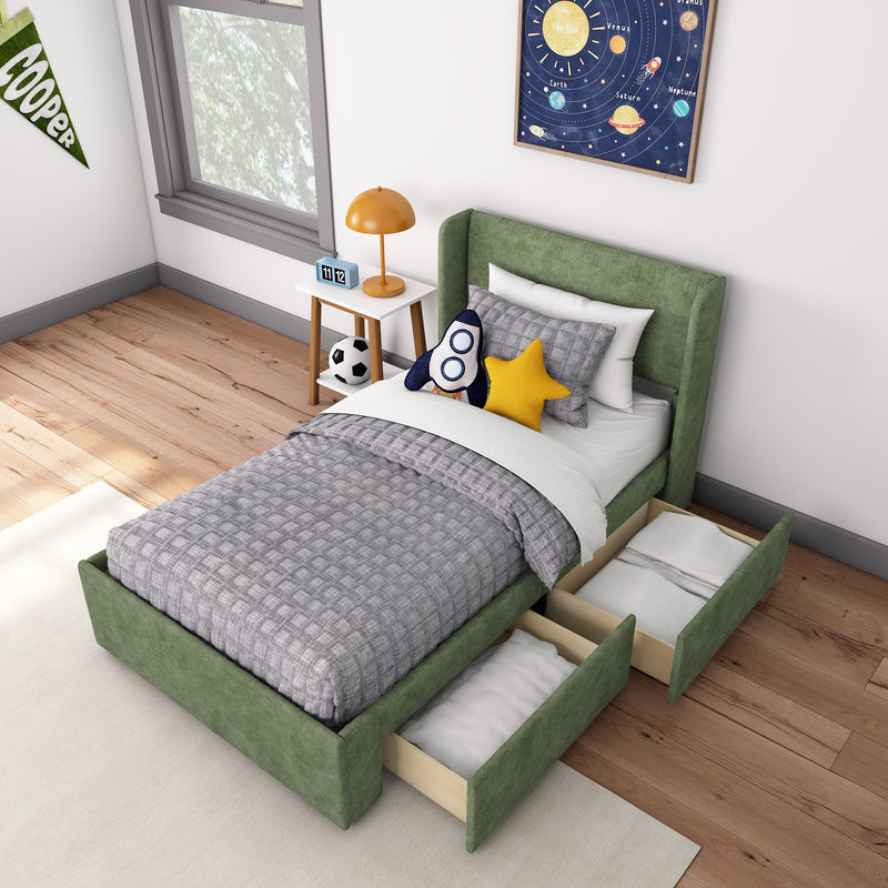 Modern kids bedroom with green upholstered storage bed and pull-out drawers, rocket plush toy, yellow star pillow, space-themed planet wall art, orange bedside lamp and hardwood floors