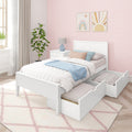 White trundle bed with storage drawers and pastel bedding in kids' bedroom with pink scallop wallpaper and rainbow wall art
