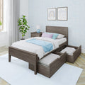 Gray wood storage bed with pull-out under-bed drawers, white and pastel bedding and blue throw, matching nightstand and lamp, potted plant and patterned blue wallpaper in a bright children's bedroom