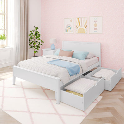 Pastel pink kids bedroom with white storage trundle bed and drawers, soft quilted bedding with blue and pink pillows, nightstand lamp, potted plant, and rainbow nursery wall art