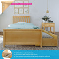 Solid New Zealand pine single platform bed with underbed trundle storage, light wood finish, blue polka-dot bedding, matching pine nightstand with vase and framed botanical wall art — plywood slats, countersunk color‑matched hardware and 400lb support bar