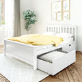 Minimal white storage bed with pull-out drawer and yellow polka-dot duvet in bright modern bedroom with plant and botanical wall art