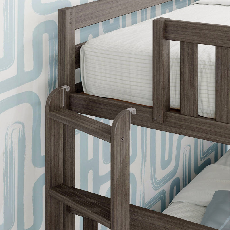 Close-up of a modern gray wood bunk bed ladder and guardrail with white striped mattress and blue abstract wallpaper, kids bedroom furniture
