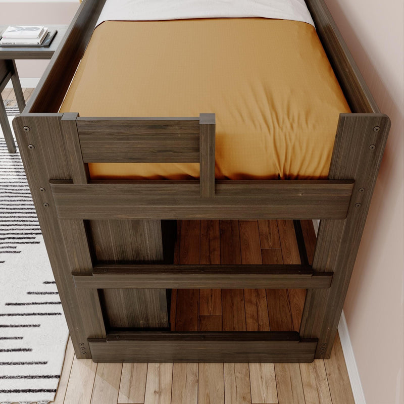 Modern rustic wooden twin loft bed with orange fitted sheet, guard rails and under-bed storage on hardwood floor in a children's bedroom