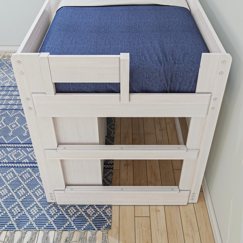Top-down view of a white wooden twin loft bed with navy blue fitted sheet, blue geometric area rug and hardwood floor in a modern kids' bedroom