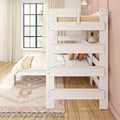 White wooden bunk bed in a cozy girls bedroom with neutral bedding and accent pillows, pink accent wall, black-framed window, cream curtains and hardwood floor