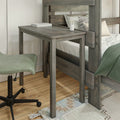Rustic gray wooden bunk bed with attached desk, book and pencil holder, green accent chair on hardwood floor — compact small bedroom workspace solution