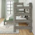 Rustic gray wooden bunk bed in a bright modern farmhouse kids' bedroom with green bedding, patterned rug, large grid window, and wall sconce