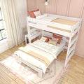 White wooden loft bunk bed with built-in desk, boho pillows and layered bedding in a pastel pink kids' bedroom with natural rug and linen curtains