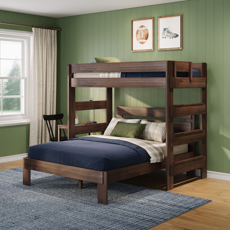 Dark wood bunk bed with built-in desk in a kids' bedroom with green paneled walls, navy bedding and framed sports prints