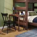 Modern kids bedroom with dark wood bunk bed featuring built-in desk, blue desk lamp and pencil cup, plaid bedding with green throw pillow, black chair, green paneled wall and hardwood floor with blue rug
