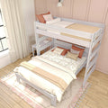 White wooden twin-over-full bunk bed with loft desk, cream bedding and peach accent pillows in a bright neutral bedroom with curtains and wood floor